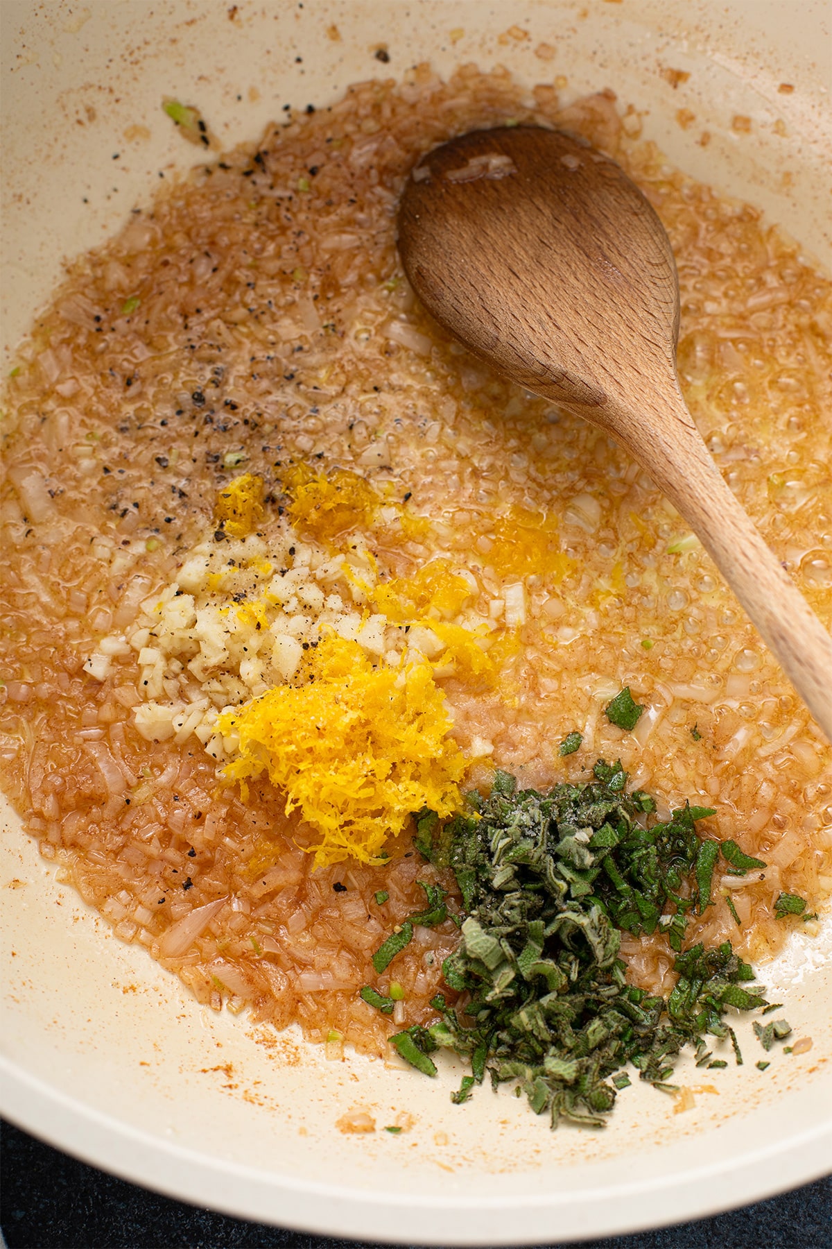 Garlic, lemon zest and chopped sage added to browned butter and shallots.